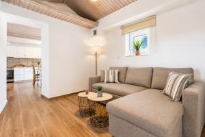 a living room with a couch and a table at Oak Tree Cottage in Pefkias