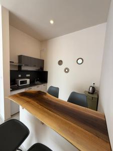 a kitchen with a wooden table and chairs at NM Residence 2 in Shkorpilovtsi