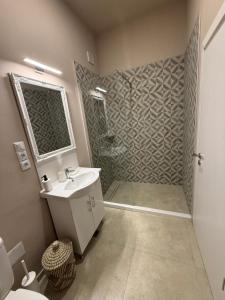 a bathroom with a shower and a sink and a toilet at NM Residence 2 in Shkorpilovtsi