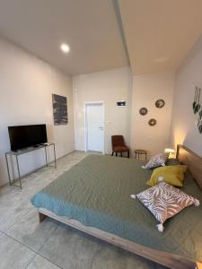 a bedroom with a large bed and a flat screen tv at NM Residence 2 in Shkorpilovtsi