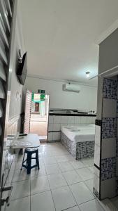 a room with a bed and a table in it at Pousada Zambaiam in Torto