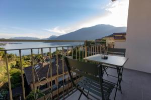 a balcony with a table and a view of the water at B&B Abbazia di Piona in Colico
