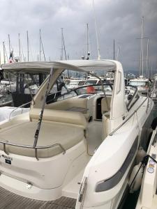 a white boat parked in a marina with other boats at Escapade Antiboise avec parking inclus in Antibes +2 photos