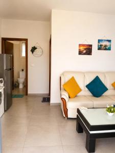 a living room with a couch and a table at The Pine House in Fier