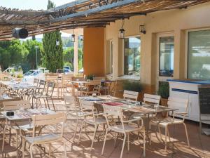 a group of tables and chairs on a patio at ibis La Ciotat in La Ciotat