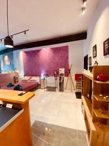 a large living room with a purple wall at Corfu port apartment in Mantoúkion