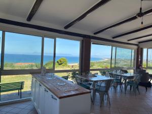 a restaurant with tables and chairs and a view of the ocean at B&B Sunset da carla in Agropoli