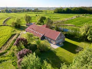 an aerial view of a house in a field at Gulfhof Wangermeer 1 Lotta in Hohenkirchen