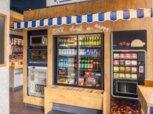 a fast food store with a refrigerator with drinks at ibis budget Berlin Alexanderplatz in Berlin