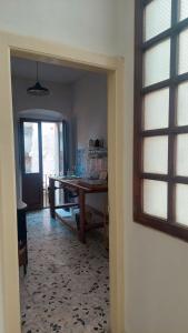 a dining room with a table and a dining roomiasm at Sa Bonora in Iglesias