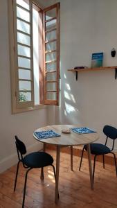 a table and chairs in a room with a window at Sa Bonora in Iglesias
