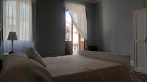 a bedroom with a large bed with a window at Sa Bonora in Iglesias +8 photos