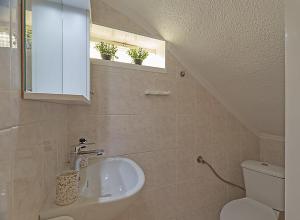 a bathroom with a sink and a toilet and a window at Big Blue Pefkohori in Pefkochori +13 photos