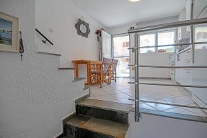 a staircase leading to a room with a table at Big Blue Pefkohori in Pefkochori