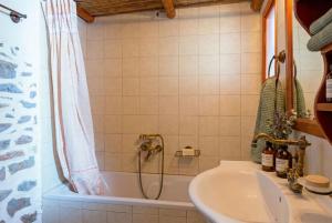 a bathroom with a shower and a sink and a tub at Elounda Almond Tree Villa Private Pool, Sea Views & Birds in a Relaxing Authentic Cretan Escape in Vrouchas +80 photos