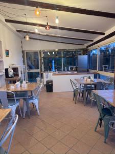 a restaurant with tables and chairs and a kitchen at B&B Sunset da carla in Agropoli