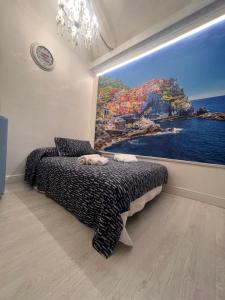 a bedroom with a large painting on the wall at LE CINQUE VELE ***** Cinque Terre in Monterosso al Mare +149 photos