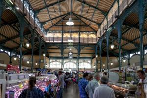a group of people walking around a market at Hôtel du Clos Fleuri in Lourdes