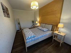 a bedroom with a bed with blue and white pillows at Babite Quiet Apartment in Babīte