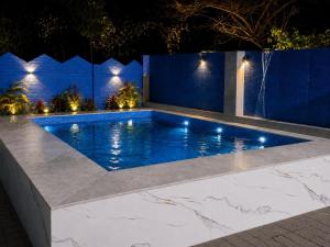 a swimming pool at night with lights at Vibhor peace cottage in Chitrakoot