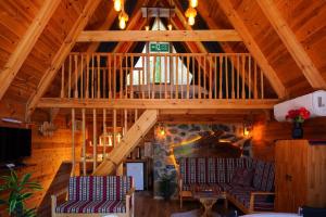 a living room with two chairs and a wooden ceiling at Doğallife suit bungalow in Çamlıhemşin