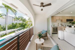 an open living room and kitchen with a large window at Casa Coral - Boca Poolside Escape in Boca Raton +28 photos