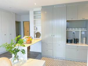 a kitchen with white cabinets and a counter at Suite 10 in Windhoek +4 photos