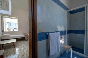 a bathroom with a shower with blue and white tiles at Pensione Di Lustro in Forio d'Ischia +92 photos