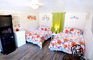 a bedroom with two beds and a dresser at Whitehall Cottages in Whitehall +6 photos