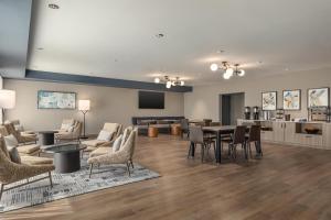 a large living room with a table and chairs at Hyatt Studios Harrisonburg in Harrisonburg