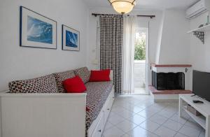 a living room with a couch and a television at Big Blue Pefkohori in Pefkochori