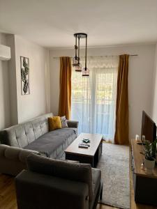 a living room with a couch and a table at Montenegro Suite Rental in Bar