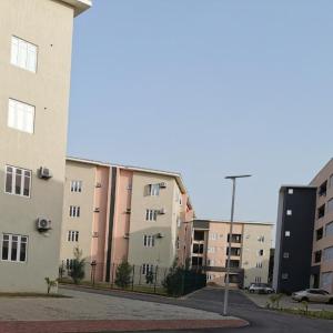 a row of apartment buildings in a city at Olivewood Apartments in Ankuru
