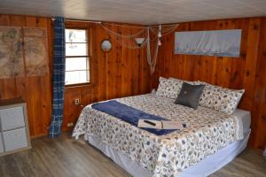 a bedroom with a bed with a laptop on it at Whitehall Cottages in Whitehall