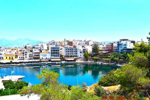 a view of a city with a marina and buildings at Luxury Lake View in Agios Nikolaos