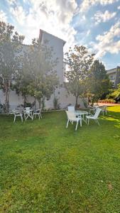 a group of tables and chairs in the grass at Studios Periklis in Limenas