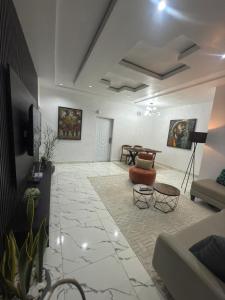 a living room with a couch and a table at Olivewood Apartments in Ankuru