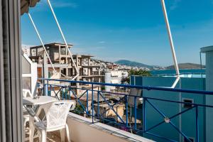 a balcony with chairs and a view of a city at Elidon Apartments in Sarandë