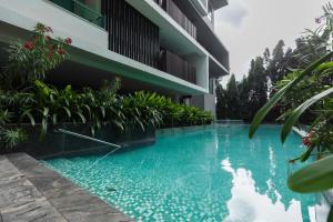a swimming pool in front of a building at SOLARIS APARTMENT-Sky Suites in Accra