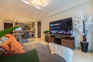 a living room with a large flat screen tv at SOLARIS APARTMENT-Sky Suites in Accra