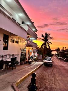 a car parked next to a building with a palm tree at Hotel Miramar - La Paz in La Paz +26 photos