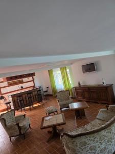 a living room with a piano and chairs at Happy Family in Suceviţa