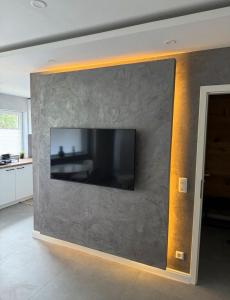 a tv on a wall in a living room at Appartement Christina in Barsinghausen