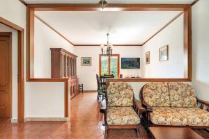 a living room with two chairs and a table at Casa Yunger in Deiva Marina