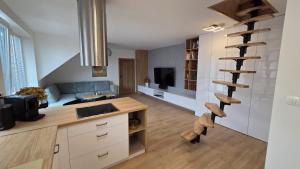 a kitchen with a spiral staircase in a room at Bytík Hlohovec Centrum in Hlohovec