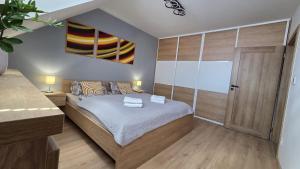 a bedroom with a bed and a wooden door at Bytík Hlohovec Centrum in Hlohovec