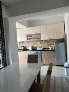a kitchen with white cabinets and a counter top at Apartment ANGELA Ohrid in Ohrid