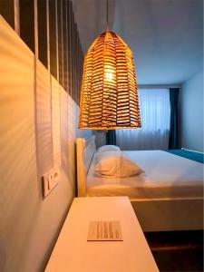 a room with two beds and a table with a light at La Cupric in Sarichioi