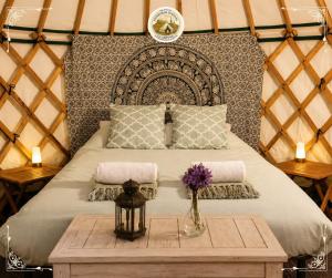a bedroom with a bed in a yurt with a table at Edinburgh Festival Glamping By Stay Social Stays in Edinburgh