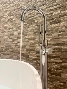 a water fountain in a bathroom with a sink at CUEVAS del PEÑÓN in Grazalema +25 photos